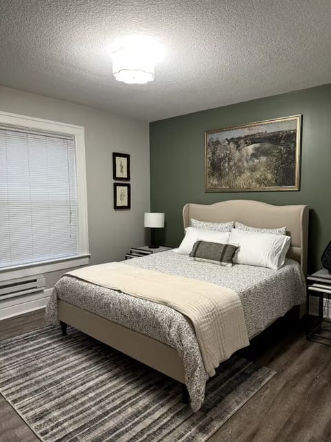 Sink into a plush queen bed layered with soft linens, ready for a night of deep, easy rest.