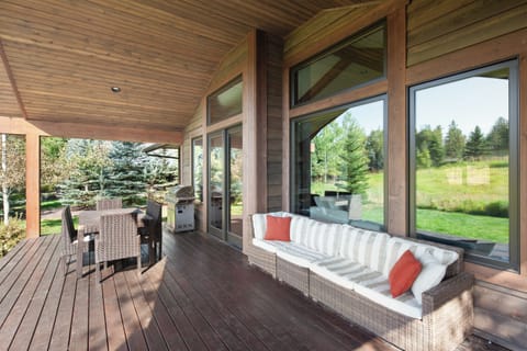 Sip coffee on the covered deck with peaceful forest air.
