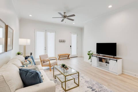 Open living area with desk space, smart TV, books, games, puzzles, and a landing area by the front door. 