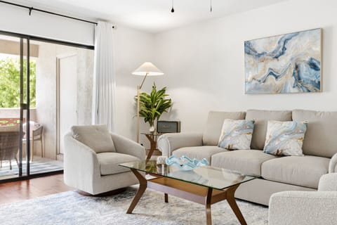 Bright, stylish living room with private balcony and cozy seating