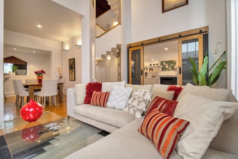 Bright open-concept living room with high ceilings and designer touches