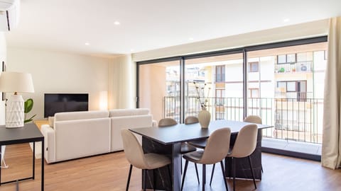 Enjoy the bright and airy open-concept living and dining area, perfect for entertaining or simply relaxing, with direct access to a private balcony overlooking the neighborhood. The large sliding glass doors flood the space with natural light, offering an