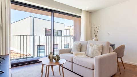 Enjoy bright, comfortable moments in this inviting living area, featuring a cozy sofa perfect for relaxing after a day of exploring, with direct access to a private balcony for fresh air and neighborhood views. #LivingRoom #CozyStay #BalconyAccess #Bright