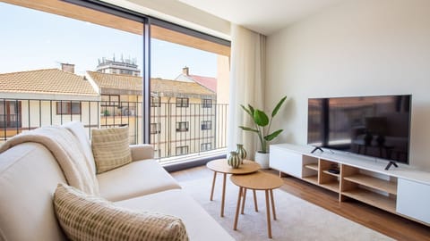 Unwind on the comfortable sofa, basking in abundant natural light and enjoying dynamic city views from your private balcony. This inviting space is thoughtfully designed for ultimate relaxation and memorable moments, connecting you with the vibrant surrou