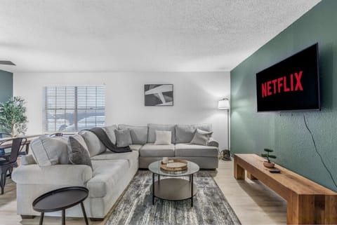 Spacious and inviting living area with comfortable seating and a smart TV, perfect for relaxing after exploring Arlington or attending events at AT&T Stadium.