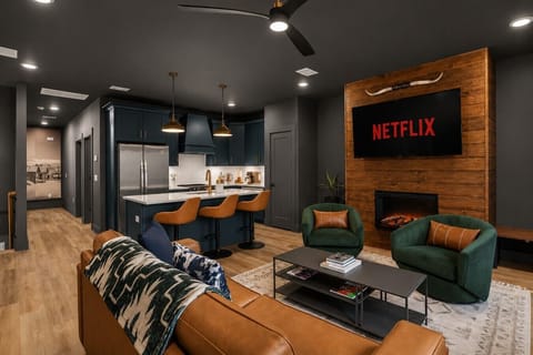 Moody modern retreat with a fireplace, gourmet kitchen, and theater vibes.