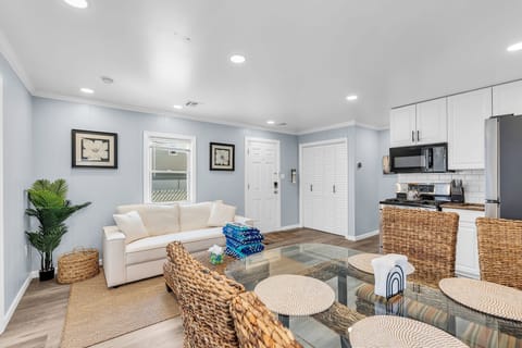 Bright coastal-style living space with dining area and modern kitchen