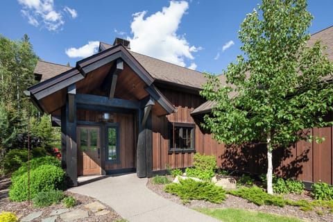 Arrive to a private, lodge-style entrance nestled in greenery.