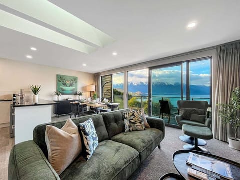 Open-plan living, dining, and kitchen area with stunning lake and mountain views
