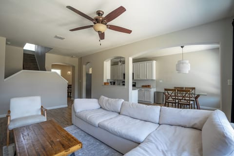 Bright open living space with large sectional and dining area