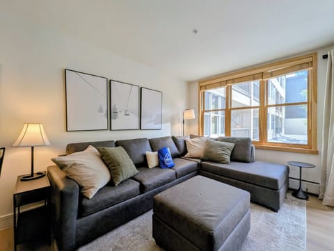 Settle into your comfortable living room, where plush seating and warm lighting create the perfect space to unwind after your mountain adventures.