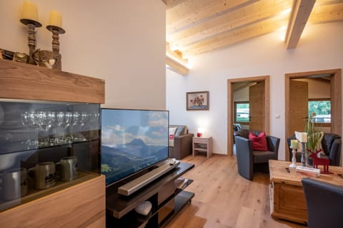 Book a luxury vacation apartment in the Brixental with spacious living room, refined Alpine style, private sauna, balcony and ski bus access.