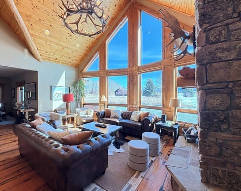 Gather, relax, and make lasting memories in this breathtaking great room, with a wall of windows that flood the space with natural light. Take in incredible views as you unwind in a warm, inviting space designed for connection and comfort!