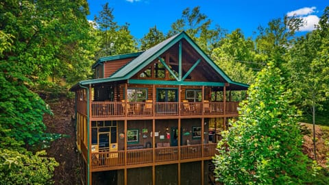 Pull up and feel it immediately — twelve people, one jaw-dropping cabin, and the Smoky Mountains wrapped around every side.