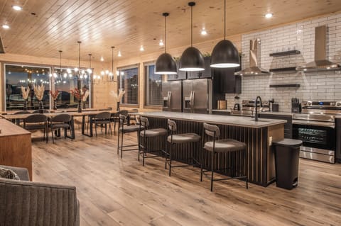 Enjoy a massive chef's kitchen flowing into the dining area with seating for 25 and views of the mountain ranges of the Smokies off the back deck.