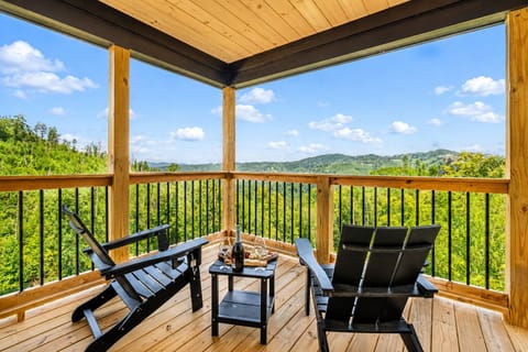 Relax on the covered deck while enjoying comfortable outdoor seating and beautiful Smoky Mountain views.