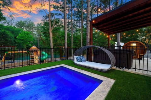 Private resort in the pines: heated pool, hot tub, sauna + playset here, with pickleball, basketball, fire pit & outdoor cinema just around the other side.