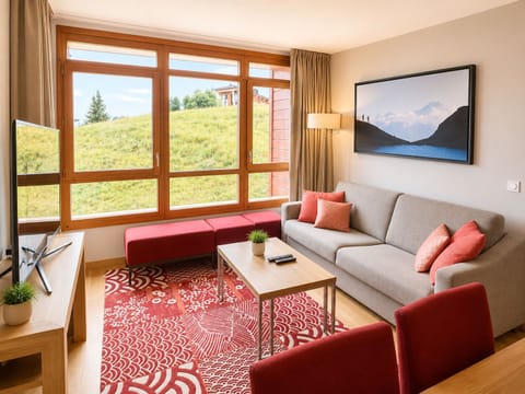Chalet-style living space with red patterned rug and mountain view