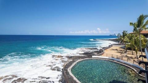 The property's seaside pool captures stunning turquoise waters and swaying palms, creating your own tropical paradise just steps from the ocean.