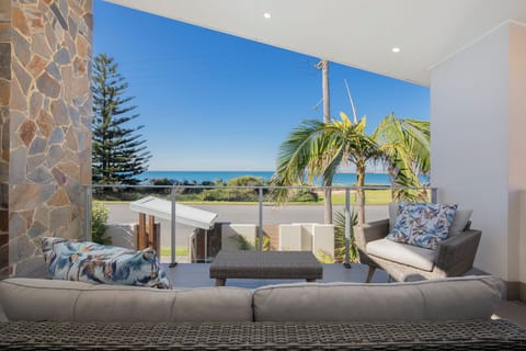 Watch ships glide through the harbour entrance from the balcony, where elevated views stretch across the coastline and the sparkling Pacific Ocean.