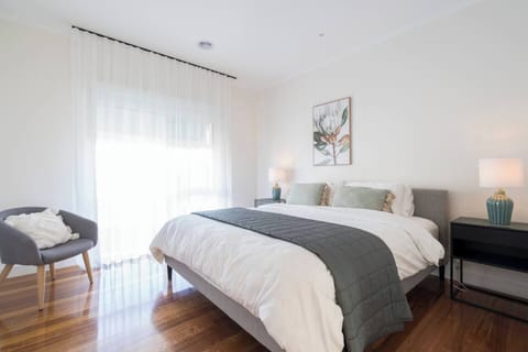 Sink into the queen bed in the primary bedroom, complete with stylish bedside lighting, a walk-in wardrobe and an ensuite for a comfortable experience.