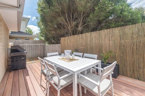 The deck offers a leafy outdoor sanctuary with a gas BBQ, dining setting, and a tranquil ambience, ideal for unhurried lunches or breezy twilight dinners.