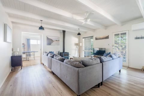 Unwind in the living area with plush seating, a TV for easy movie nights, and a wood-burning fireplace that brings warmth and ambience to relaxed evenings together.