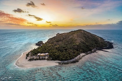 Private island escape with sandy shores and stunning sunset views