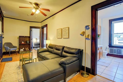 Comfortable living room with a sectional sofa, smart TV, and warm lighting—perfect for relaxing evenings or working from home in a cozy setting.