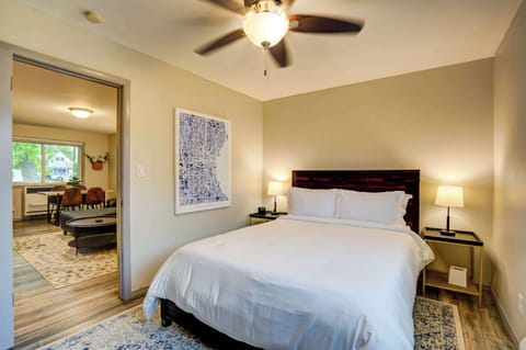 Inviting bedroom with a plush queen bed, soft lighting, and ceiling fan—perfect for a restful night’s sleep.