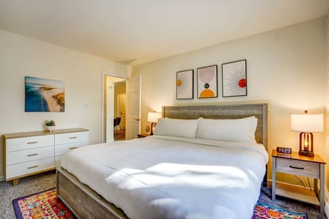 Peaceful bedroom featuring a plush king bed, modern decor, and warm lighting. Thoughtful touches and natural light create a welcoming retreat for rest and relaxation.