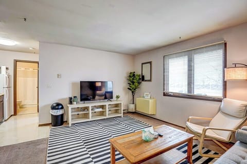 Living room with Roku Smart TV, couch and chair. You can see the VA hospital out the window!