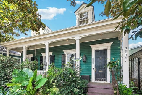 Charming exterior entrance surrounded by lush New Orleans greenery