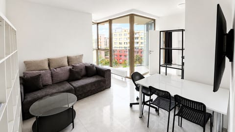 Bright modern living room with corner windows and city views