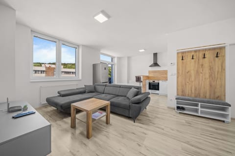 Bright open-plan lounge with modern kitchen and spacious sectional