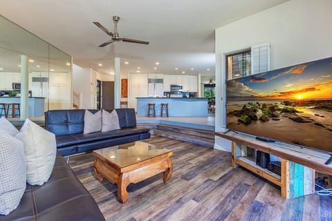 Settle into this bright, open-concept living space with comfortable seating and sweeping views of the modern kitchen.