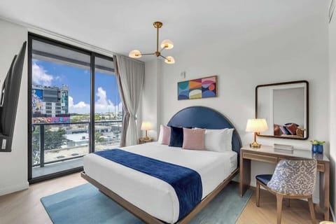 Get comfortable! This spacious room features a plush King bed positioned perfectly for a movie night on the large smart TV. Enjoy the clean, modern design and convenient layout with plenty of space to unpack and unwind.