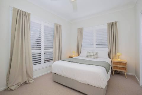 Sink into the queen bed in the primary bedroom, where soft neutral tones, plantation shutters and an ensuite create a calm retreat at the end of the day.