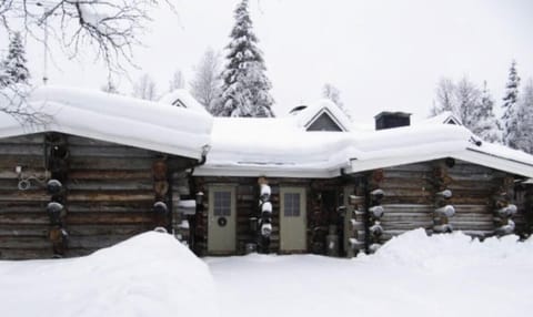 Snow-covered kelo log building in winter.