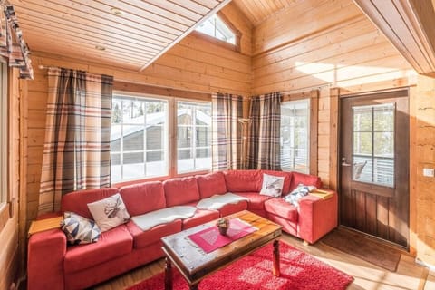 Spacious living room with a large corner sofa and bright windows.