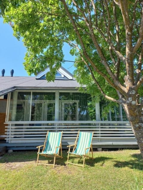 Exterior view of the large glass-enclosed terrace surrounded by trees.