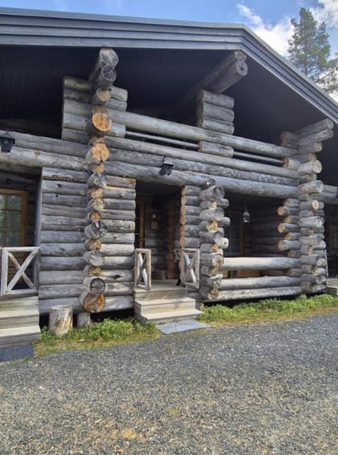 Exterior view of the log building with its own private entrance and steps up to the door.