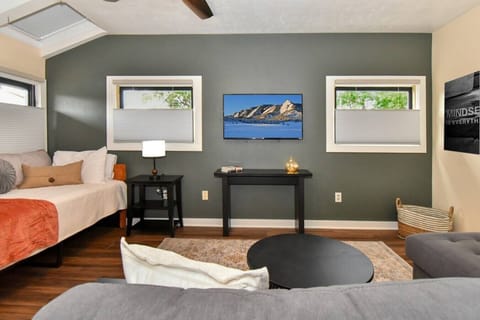 Versatile bonus room featuring a cozy twin bed and comfortable sofa bed—perfect for extra guests, relaxing, or enjoying a movie night.