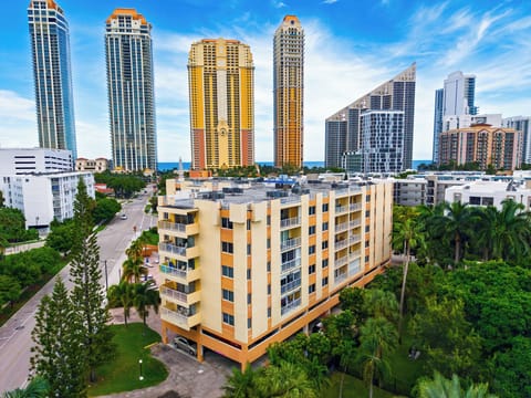 Striking aerial perspective with the condo building foregrounding Miami's coastal towers.
