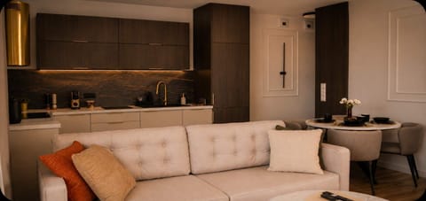 A cozy living room with a cream sofa, coffee table, and dark wooden finishes.