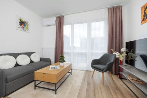 Relax in the stylish living room with a comfortable sofa and modern decor.