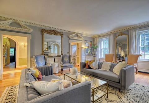 Elegantly furnished living room featuring a classic piano — perfect for relaxing or gathering with friends and family.