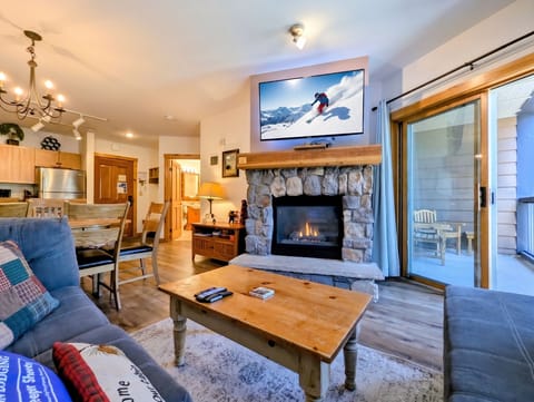 Mountain retreat featuring a warm stone fireplace and an open living area perfect for relaxing after a day of adventure.