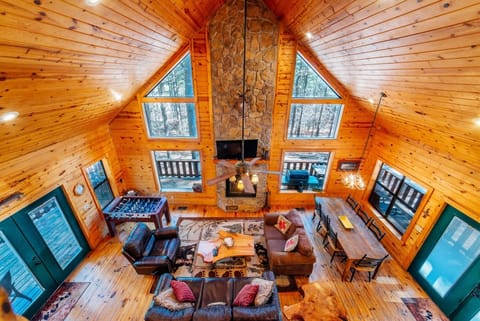 Soaring ceilings wrapped in warm knotty pine frame your cozy retreat, where you'll gather around the majestic stone fireplace and watch the forest through dramatic cathedral windows.