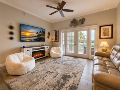 Comfortable living room with a massive Smart TV, private balcony, and beautiful views